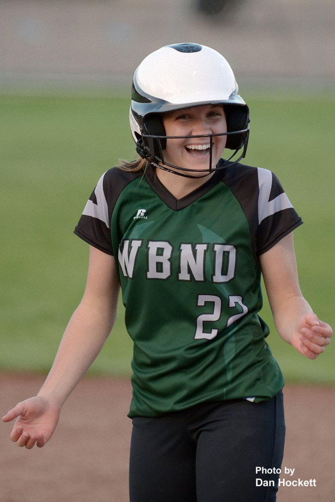 Photo by Dan Hockett West Burlington – Notre Dame’s Shayleigh Abbott celebrates her first varsity hit against the Harmony Rockets Thursday night in West Burlington. WBND defeated Harmony, 22-0, in 3-innings. 